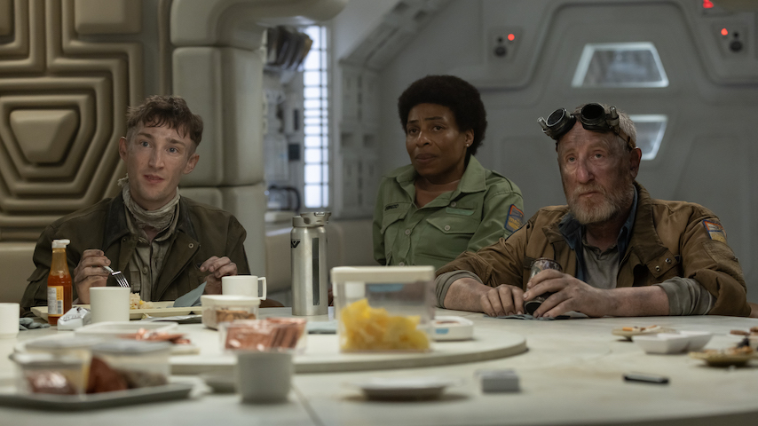 A trupe de uma nave espacial ao redor de uma mesa